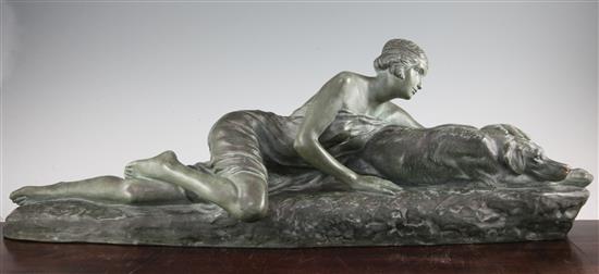 Louis Riche. A French Art Deco green painted terracotta model of a reclining female and hound, 33in.